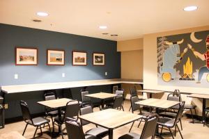 a dining room with tables and chairs in it at Sleep Inn & Suites Conference Center Eau Claire North in Union