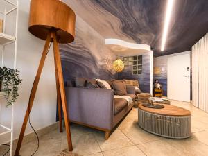 a living room with a couch and a table at Apartamento Triplex Boutique - 39JurereByTheSea in Florianópolis