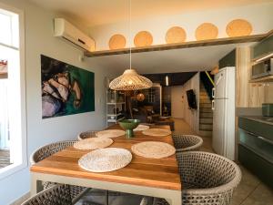 a dining room with a wooden table and chairs at Apartamento Triplex Boutique - 39JurereByTheSea in Florianópolis +161 photos