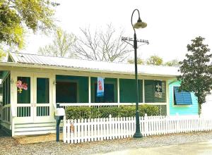 a house with a white fence and a street light at Hotty Toddy in Bay Saint Louis