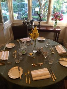 a table with a black table cloth with plates and silverware at Willowlodge in Scottsdale