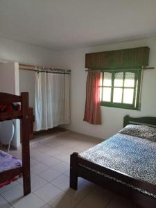 a bedroom with two beds and a window at Depto Villa Gesell in Villa Gesell