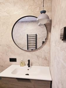 a bathroom with a sink and a mirror at Lazy House Latvia in Jūrmalciems +62 photos