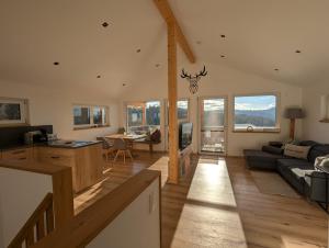 a large living room with a couch and a table at Chalet Zeitlos - Bodenmais in Bodenmais