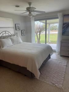 a bedroom with a large bed and a window at Pool home on the Bay, large private yard near AMI in Bradenton +67 photos