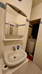 a bathroom with a white sink and a mirror at Piste Terminillo Appartamento Centro in Terminillo +27 photos