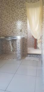 a bathroom with a toilet and a curtain in a room at Aconchego de Matias in Matias Barbosa +9 photos