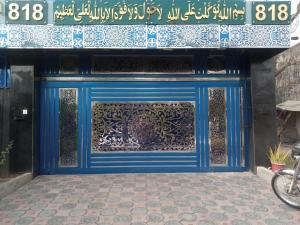 a blue door with a sign on a building at 818 GUEST House HOUSE 818 STREET 11 I-8 in Islamabad