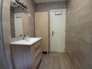 a bathroom with a sink and a mirror and a door at Entrepinos in Guisando +9 photos