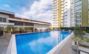 a large swimming pool in front of a building at La Vie Suite at MesaVerte Residence in Cagayan de Oro
