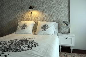 a bedroom with a bed with two pillows on it at Gastenkamers Boussemaere in Ichtegem