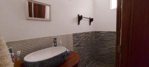 a bathroom with a sink and a mirror at Tamarin Beach House in Tamarin