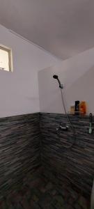 a bathroom with a shower in the corner of a room at Tamarin Beach House in Tamarin +9 photos