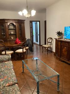 a living room with a glass table and chairs at LA CASA FRA gli ULIVI UMBRA in Terni +9 photos