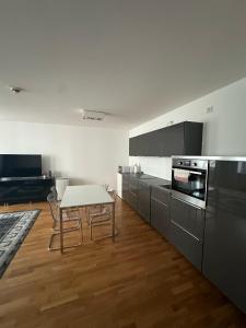 a kitchen with a table and chairs in it at Al Nafurah Apartments in Munich +87 photos