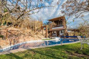 a house with a swimming pool in a yard at Hotel Casa Cantera in El Carmen