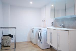 a laundry room with two washes and a sink at Ferienhaus Nia in Altenau