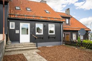a black house with an orange roof at Ferienhaus Nia in Altenau