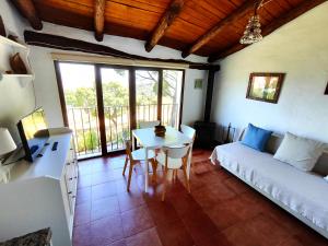 a living room with a table and a couch at Las Casas de la Tía Sabina in Cortelazor