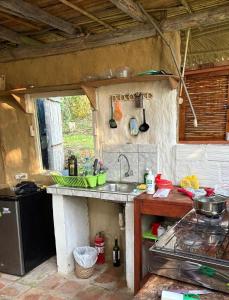 a kitchen with a sink and a counter top at Sweet little cabin in ecological artist community in Tarapoto