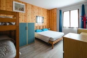 a bedroom with a bed and a bunk bed at Casa vacanza Miralago in Antronapiana