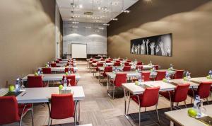 a dining room with tables and chairs and a whiteboard at Hotel Sercotel Ciutat D'Alcoi in Alcoy +36 photos