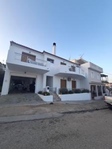 a large white house with a parking lot at D and D Home Alonissos in Alonnisos