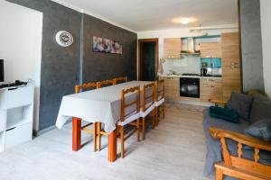 a kitchen and living room with a table and a couch at Casa vacanza Miralago in Antronapiana