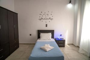 a bedroom with a bed and a clock on the wall at Levanda House in Palekastron