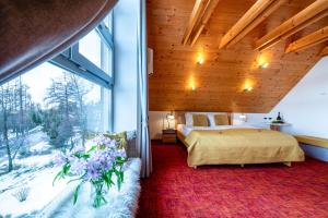 A bed or beds in a room at Boutique Hotel Vila Lieska