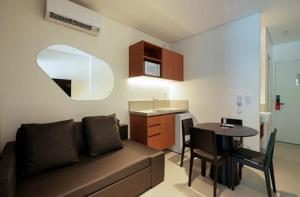 a living room with a couch and a table at PORTO ALTO RESORT - GAV - Praia do Muro Alto in Ipojuca