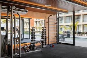 a gym with fitness equipment in a building at PORTO ALTO RESORT - GAV - Praia do Muro Alto in Ipojuca