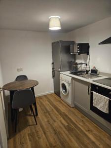 a kitchen with a washing machine and a table at The Dell - Rushden Lakes in Rushden +27 photos