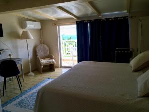 A bed or beds in a room at Hotel Cap Sud Caraibes
