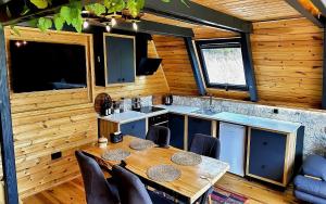 a kitchen and dining room with a table and chairs at paradise valley bungalow in Ardeşen +14 photos