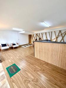 a large room with a wooden floor and a counter at Recanto Vizinho do Mar in Ubatuba +37 photos