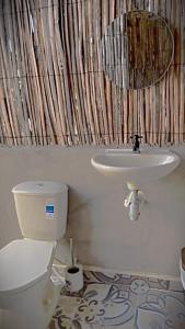 a bathroom with a toilet and a sink at Mayapo Liwa in Manaure