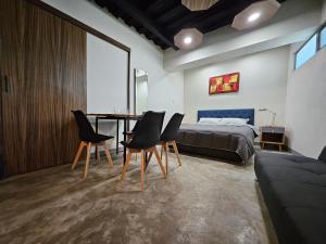 a bedroom with a bed and a table and chairs at Relaxed and private in Jiquilpan de Juárez