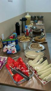 a table topped with lots of food on top at Hotel Bee's Sorriso in Sorriso