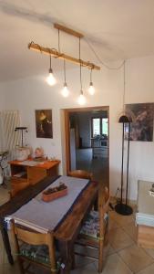 a living room with a table and a dining room at Casa in Maremma in Montemerano