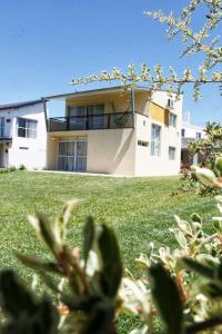 a house on a hill with a green yard at Serendipia Santa Ana in Santa Ana