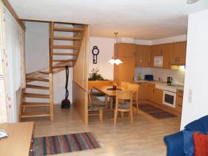 a kitchen and dining room with a spiral staircase in a room at Ranner's Ferienwohnung in Hermagor