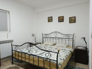 a bedroom with a metal bed with pillows on it at Mountain Relax Vlašić in Vlasic