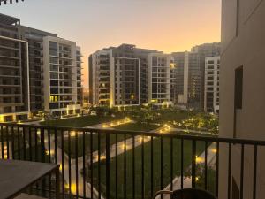a view of a city at night from a balcony at Zed towers El sheikh ZAYED zed park 3 in Sheikh Zayed