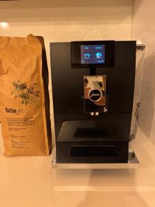 a coffee machine with a paper bag next to it at Landhaus 1868 in Villenbach