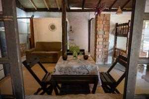 a table and chairs in a room with a couch at Pousada Gendra's in Imbituba