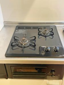 a stove top with two burners on top of it at Chill Fortuna Shimokitazawa Tokyo in Tokyo