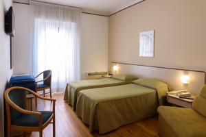 Postel nebo postele na pokoji v ubytování Hotel Italie et Suisse