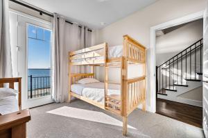 a bedroom with bunk beds and a view of the ocean at Charming Lake House Retreat In Rowlett in Rowlett