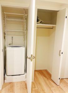 a laundry room with a washer and dryer at Chill Fortuna Shimokitazawa Tokyo in Tokyo +20 photos